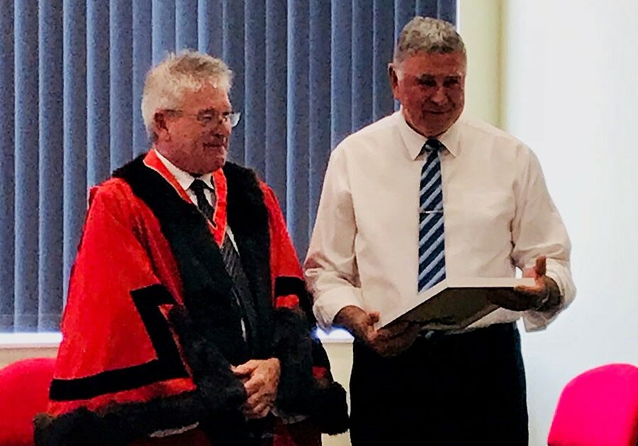 Kevin Bailey receiving his Australia Day award from the Mayor of the West Coast, Phil Vickers.